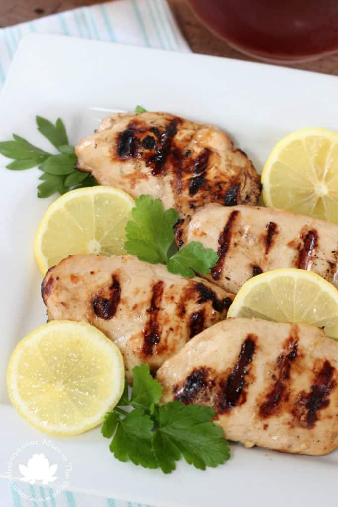 marinated chicken on plate with lemons